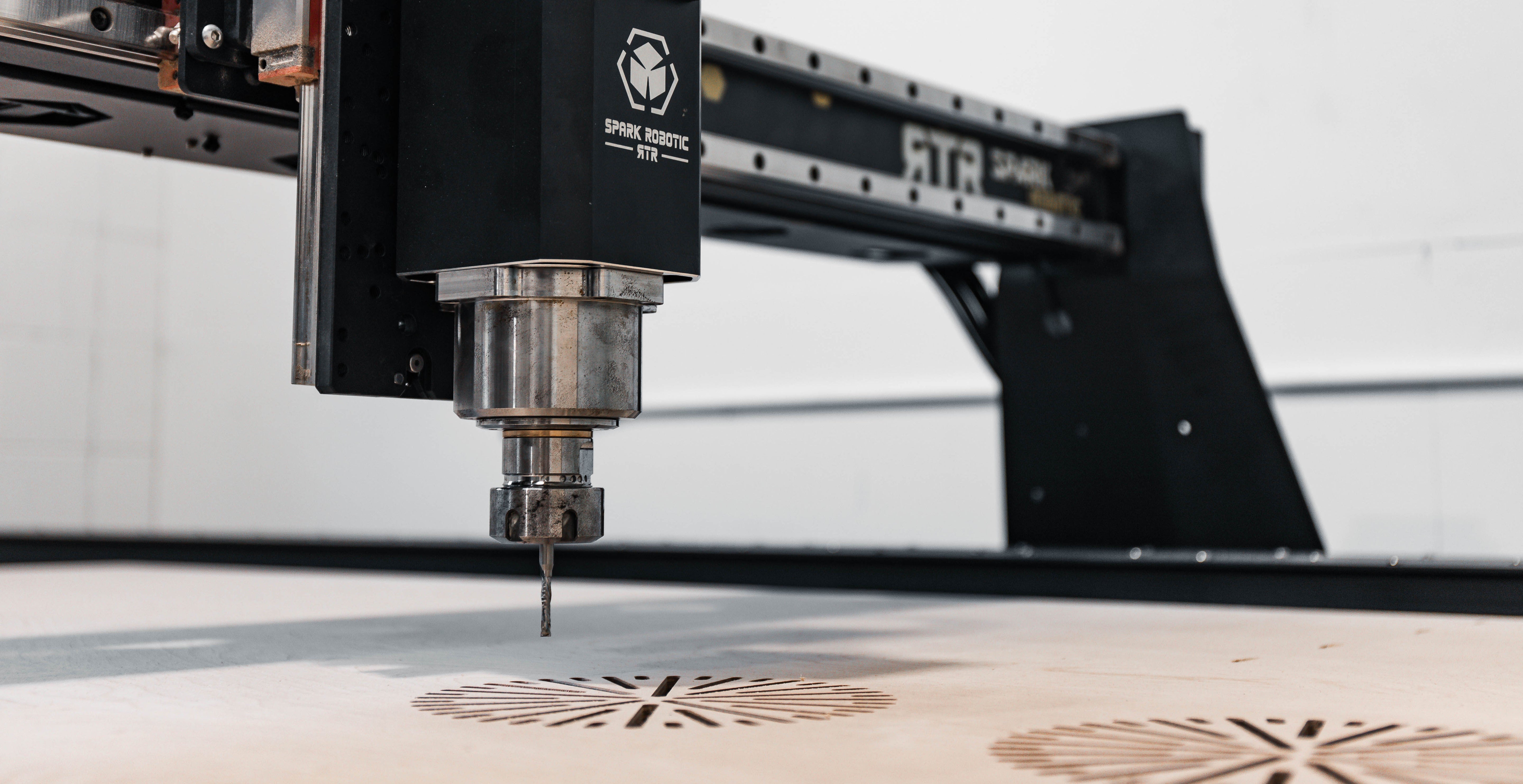 CNC machine in operation with a detailed pattern on a surface.