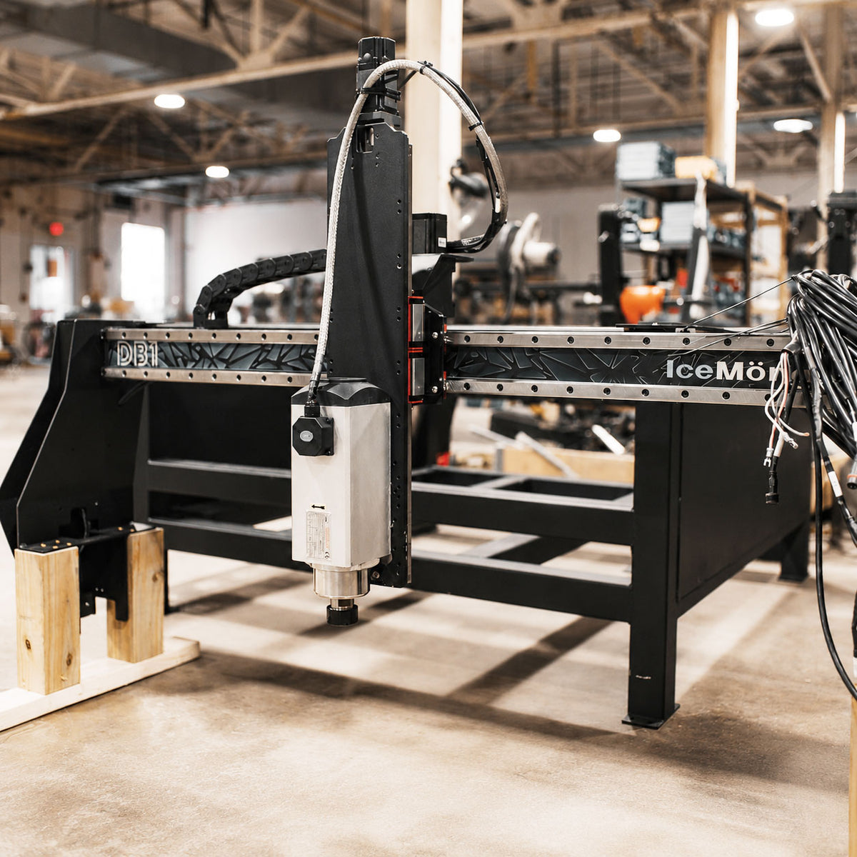 CNC machine in a workshop setting with visible branding