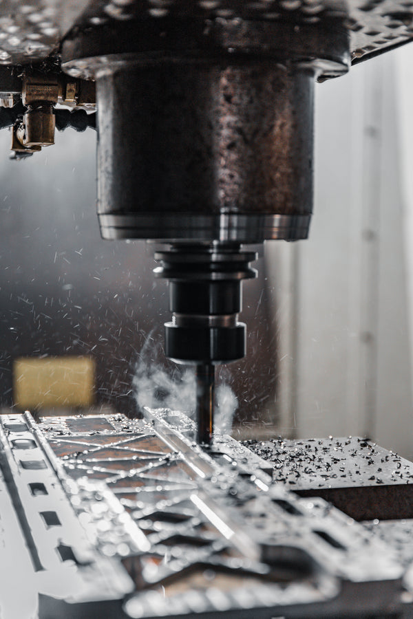 CNC machine in operation with metal parts on a workshop background
