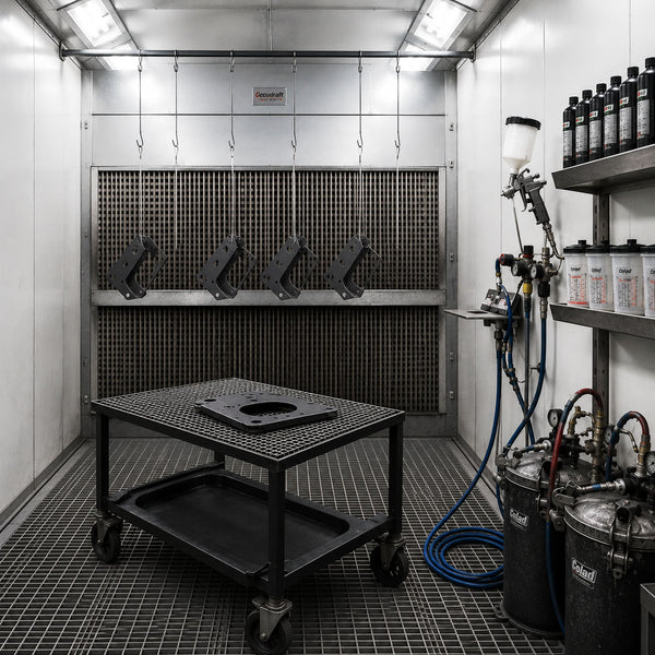 Industrial paint booth with equipment and supplies.