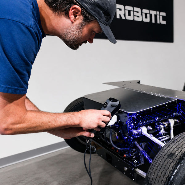 Person 3D  scanning a car engine for project recovery.